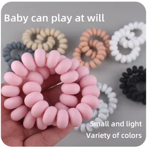 Detailed view of matte silicone spiral teether rings in various colors for baby soothing