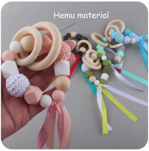 Detail showing the natural Hemu material wood rings and colorful silicone sensory beads