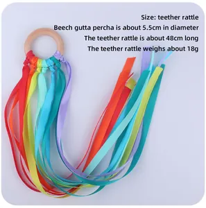 Detail of baby ribbon teether showing 5.5cm beech wood ring and colorful silk streamers