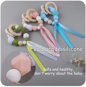 Macro shot of food grade silicone beads and wooden ring on infant teething bracelet