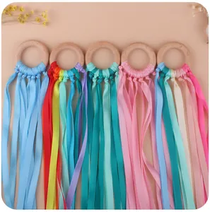 Detailed set of five baby wooden rings with colorful satin ribbons for sensory play