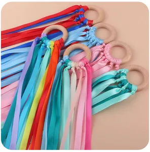 Close-up of sensory beech wood rings with colorful ribbon streamers for infant development