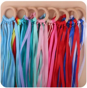 Set of seven sensory rainbow ribbon wooden rings for infant teething and grasping