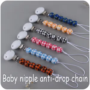 Close-up of baby nipple anti-drop chains with star beads and colorful checkered patterns