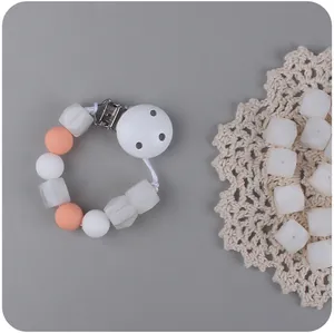 Detailed view of BPA-free silicone pacifier clip with white and orange geometric beads