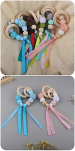 Macro view of baby teething ring with colorful silicone beads and silk ribbons