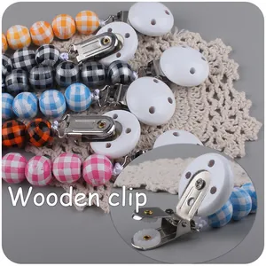 Detailed close-up of colorful wooden bead pacifier clips with a vintage checkered pattern