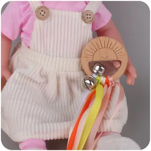 Baby wooden rattle toy with sun-shaped beech ring, colorful ribbons, and silver bells
