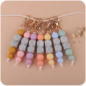 Silicone bead keychains with gold lobster clasps and marble textures in various macaron colors