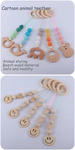 Close-up of beech wood baby teethers with cartoon animals and crochet beads detail
