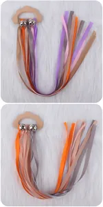 Close-up of wooden cloud teether rattle with colorful ribbons on white fur
