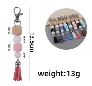 Detail view of colorful silicone bead keychain with leather tassel and size dimensions