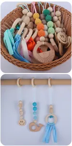 Detail of baby play gym set featuring crochet beads, beech wood rings and small bells