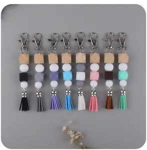 Detailed view of DIY silicone bead keychains with wooden cubes and colorful tassels