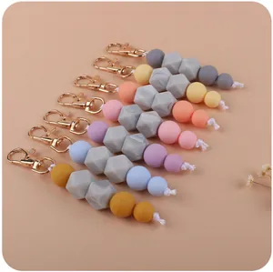 Detail of colorful marble silicone bead keychains with gold metal lobster clasps