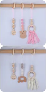 Detail view of baby gym pendants with crochet beads, beech wood animals and small bells
