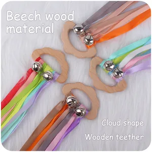 Cloud-shaped beech wood baby teether with colorful ribbons and silver bells rattle toy