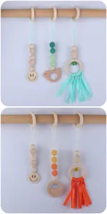 Detail view of baby gym toy set with wooden beads and crochet animals for nurseries