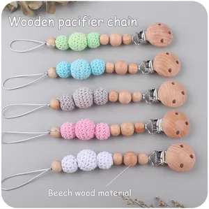 Detail showing five colors of beech wood and crochet pacifier chains with metal clips