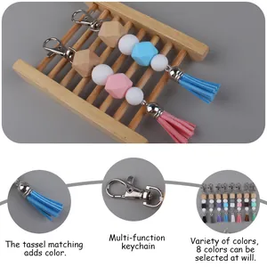 DIY colorful silicone bead keychain with wooden beads and tassel shown on wooden ladder