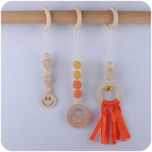 Three-piece baby gym toy set with beech wood rings, crochet beads, and bells