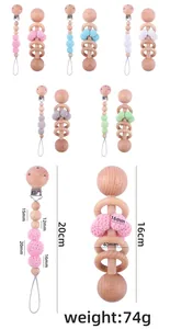 Detailed dimensions of beech wood baby rattle and knitted pacifier clip set