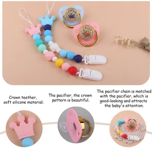 Close-up of soft silicone crown teether and luxury rhinestone pacifier set for babies