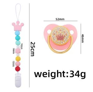 Close-up of pink silicone pacifier with rhinestone crown and beaded clip showing dimensions