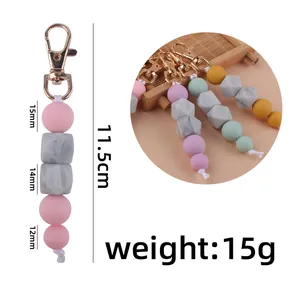 Pink and marble beaded silicone keychain with lobster clasp and dimension details
