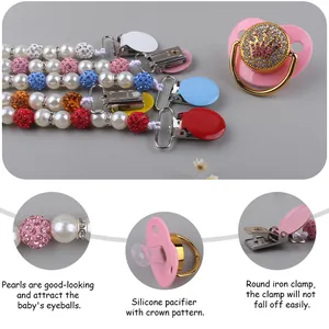 Detail of luxury crown baby pacifier with faux pearl clip and sparkling diamond accents