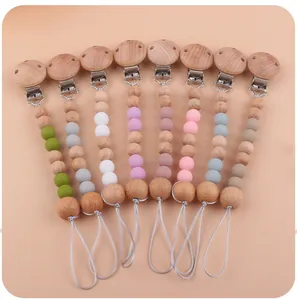 Detailed set of eight silicone and beech wood baby pacifier clips in various pastel colors