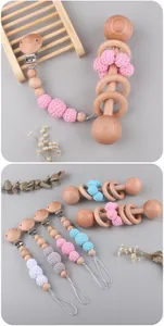 Detailed view of handmade crochet cotton balls and polished beech wood teething ring set