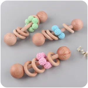Three-piece beech wood baby rattle set with colorful crochet beads in pastel tones