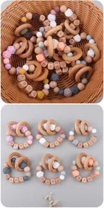 Detail of beech wood baby teether ring with silicone beads and engraved letter blocks