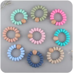 Set di nove braccialetti da dentizione in silicone per neonati con perle in legno di faggio