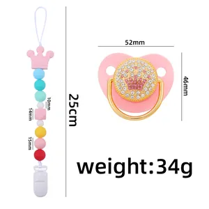 Pink silicone baby pacifier set with golden crown design and colorful beaded clip chain