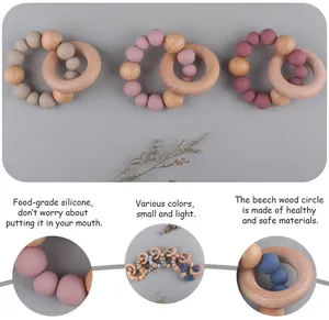 Close-up of food-grade silicone beads and natural beech wood ring for baby teething