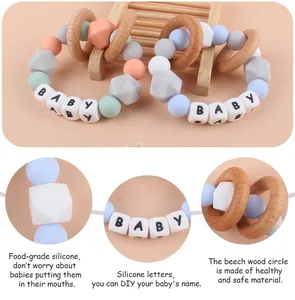 Close-up of silicone and beech wood baby teether ring with customizable DIY letter beads