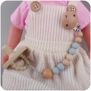 Schnullerkette mit Elefanten-Holzclip und Silikonperlen an einer Babypuppe