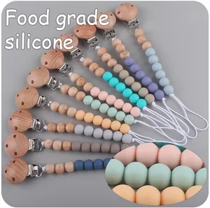 Close-up of baby pacifier clips made of natural beech wood and food-grade silicone beads