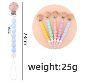 Catenella per ciuccio in silicone e faggio con dettagli su lunghezza 23cm e perle 15mm