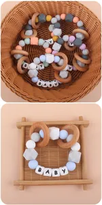 Detail of baby teething bracelet with macaron silicone beads and natural wooden rings