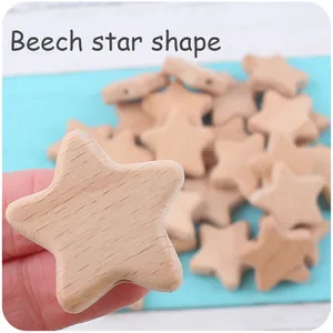 Macro shot of natural beech wood star-shaped beads for DIY pacifier clips and teething toys