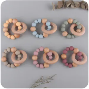 Macro detail of infant beech wood and Morandi silicone bead teething rings in six colors