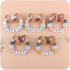 Close-up of silicone baby teether bracelets with natural wood rings and sensory beads