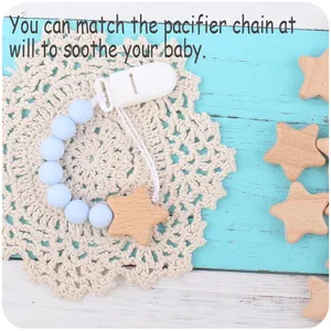 Close-up of baby pacifier clip with blue silicone beads and natural beech wood star