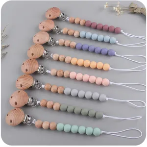 Pacifier clips set with natural beech wood and colorful silicone beads in eight soft shades