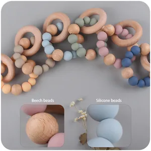 Baby teething ring made of natural beech wood and soft colorful silicone beads