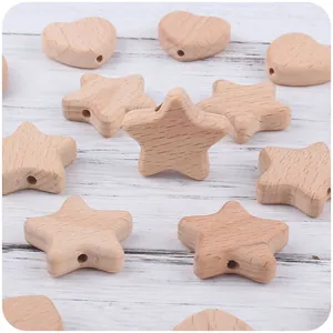 Close-up of heart and star beech wood teething beads with pre-drilled holes for DIY
