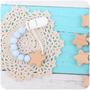 Baby pacifier clip with light blue silicone beads and natural beech wood star pendant
